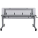 A white Luxor adjustable height nesting table with wheels.
