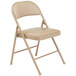 A National Public Seating beige metal folding chair with a beige padded seat.