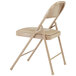 A National Public Seating beige metal folding chair with a beige padded vinyl seat.