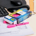 A pink Avery Hi-Liter pen on a desk with a box of Avery Hi-Liter Fluorescent Pink Highlighters.