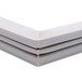 A close up of a white plastic corner on a white background.