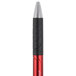 The Universal One red and black ink pen with a silver tip.