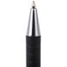 A close-up of the black and silver tip of a Universal One Comfort Grip Retractable Ballpoint Pen.