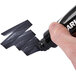 A person holding a black Avery Marks-A-Lot desk style permanent marker.