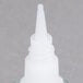 The clear plastic bottle of Krazy Glue with a white lid.