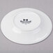 A bright white Tuxton China oil dish with black text reading "TuxTrendz Sandbar" on it.