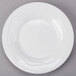 A Tuxton TuxTrendz bright white china sauce dish with a circular edge.