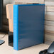 An Avery light blue heavy-duty view binder on a desk.