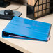 An Avery light blue binder on a desk.