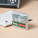 A close-up of a small box with four Krazy Glue clear single use tubes.