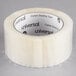 A Universal One box of 12 clear acrylic tape rolls.
