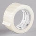 A Universal One roll of clear tape with a black label.