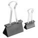 Two black binder clips with handles.