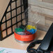 A box of Universal assorted color vinyl-coated paper clips on a desk.