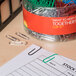 A container of Universal assorted color vinyl-coated paper clips.