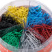 A plastic container of Universal assorted color vinyl-coated paper clips.