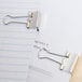 A paper with Universal small binder clips and paper clips on it.