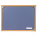 A blue Universal cork board with an oak frame.