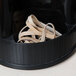 A black container with Universal beige rubber bands in it.