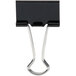 A close-up of a Universal black medium binder clip with metal arms and a metal hook.