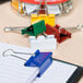 A Universal box of 24 assorted color medium binder clips.