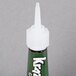 A Krazy Glue green tube with a white cap.