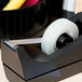 A Universal tape dispenser with Universal Clear Write-On Invisible Tape in it.