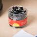 A jar of Universal black mini binder clips.