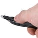 A person using a Universal black wand style staple remover.