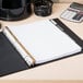 A white table with a binder using Avery Big Tab White Paper dividers and a calculator.