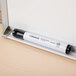 A Universal black chisel tip dry erase marker in a case.