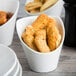 A close up of food in a TuxTrendz bright white bowl.