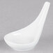 A close-up of a bright white oval Tuxton China tasting spoon.