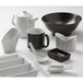 A TuxTrendz white china tasting spoon on a white plate with a white bowl.