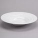 A Tuxton TuxTrendz bright white china pasta bowl with a wavy rim.