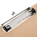 A Universal brown hardboard clipboard with a metal clip.
