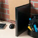 A black Avery Economy View Binder on a counter.