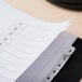 A close up of a white Avery table of contents divider.