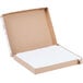 A cardboard box with a white cover and white paper inside.