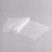 A white sheet of paper on a gray surface with a clear plastic laminating pouch.