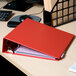 A red Universal economy non-stick binder on a desk.
