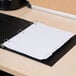 A black binder with a white Universal white 5-tab write-on/erasable divider on top.