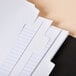 A stack of white file folders with Universal White Write-On Dividers.