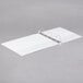 A Universal white binder with rings on it.