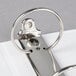 A Universal white binder with metal rings on a white background.