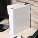 A white Universal economy non-stick view binder on a desk.