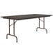 A Correll rectangular folding table with a walnut melamine top.