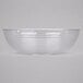 A clear Cambro Camwear round ribbed bowl on a white surface.