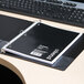 A black Universal wirebound notebook on a desk.