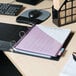 A black Universal binder with a pink paper on it.
